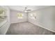 Spacious bedroom with plush carpeting, neutral walls, and plenty of natural light from two windows at 105 N Comet Ave, Clearwater, FL 33765