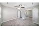 Neutral bedroom featuring a ceiling fan, closet, and convenient access to the en-suite bathroom at 105 N Comet Ave, Clearwater, FL 33765