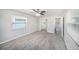 Bedroom featuring neutral walls, plush carpet, a ceiling fan, and a mirrored closet at 105 N Comet Ave, Clearwater, FL 33765
