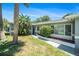 Inviting home entrance with lush tropical landscaping and a charming walkway at 105 N Comet Ave, Clearwater, FL 33765