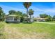 Charming single-story home boasts a well-maintained lawn and mature palm trees at 105 N Comet Ave, Clearwater, FL 33765