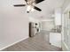 Bright kitchen featuring stainless steel appliances, white cabinets, and a view into the dining area at 105 N Comet Ave, Clearwater, FL 33765