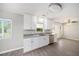 Kitchen featuring white cabinets, granite countertops, stainless steel appliances, and natural light at 105 N Comet Ave, Clearwater, FL 33765