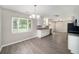 Bright kitchen features white cabinetry, stainless appliances, and modern lighting at 105 N Comet Ave, Clearwater, FL 33765