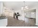 Open concept kitchen featuring stainless steel appliances, white cabinetry, and gray countertops at 105 N Comet Ave, Clearwater, FL 33765