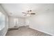 Bright living room with gray walls, wood-look floors, and a ceiling fan at 105 N Comet Ave, Clearwater, FL 33765