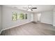 Bright living room with gray walls, wood-look floors, and a ceiling fan at 105 N Comet Ave, Clearwater, FL 33765