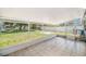 Enclosed patio area with tile floor, offering a versatile outdoor space with a view of the green yard at 105 N Comet Ave, Clearwater, FL 33765