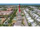 An aerial view showcases homes, mature trees and a community pool at 10560 Lake Seminole Ter, Seminole, FL 33772