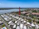 An aerial view showcasing homes, mature trees, and a distant lake at 10560 Lake Seminole Ter, Seminole, FL 33772