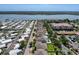 An aerial view showcases homes, a community pool, mature trees, and a waterway at 10560 Lake Seminole Ter, Seminole, FL 33772