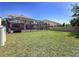 A spacious backyard featuring a screened-in patio and a well-maintained lawn at 10560 Lake Seminole Ter, Seminole, FL 33772