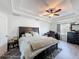 Bright bedroom featuring a tray ceiling, ceiling fan, and neutral walls at 10560 Lake Seminole Ter, Seminole, FL 33772