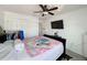 Well-lit bedroom with a ceiling fan, TV, and ample closet space at 10560 Lake Seminole Ter, Seminole, FL 33772