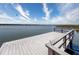 Picturesque view of a wooden dock extending into a serene lake under a cloudy sky at 10560 Lake Seminole Ter, Seminole, FL 33772