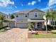 Charming two-story home featuring a three-car garage, paver driveway, and well-manicured landscaping at 10560 Lake Seminole Ter, Seminole, FL 33772