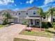 Charming two-story home featuring a three-car garage, paver driveway, and well-manicured landscaping at 10560 Lake Seminole Ter, Seminole, FL 33772