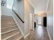 Hallway view showcasing stairs, tile floors, and a light and airy color palette at 10560 Lake Seminole Ter, Seminole, FL 33772