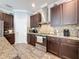 Spacious kitchen featuring granite countertops, mosaic backsplash, and stainless steel appliances at 10560 Lake Seminole Ter, Seminole, FL 33772