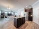 A modern kitchen featuring an island with a granite countertop and stainless steel appliances, seamlessly connected to the living area at 10560 Lake Seminole Ter, Seminole, FL 33772