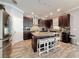 Spacious kitchen with granite countertops, stainless steel appliances, and an island with seating at 10560 Lake Seminole Ter, Seminole, FL 33772