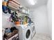Laundry room with white washer and dryer, and shelving at 10560 Lake Seminole Ter, Seminole, FL 33772