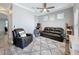 Comfortable living room with ceiling fan, neutral color palette, and ample natural light at 10560 Lake Seminole Ter, Seminole, FL 33772