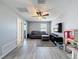 Upstairs living area with neutral walls, laminate floors, and a gray sofa at 10560 Lake Seminole Ter, Seminole, FL 33772