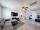 Gray living room offering gray wood-look floors and a large gray sofa at 10560 Lake Seminole Ter, Seminole, FL 33772