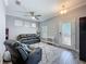 Comfortable living room with ceiling fan, neutral color palette, and ample natural light at 10560 Lake Seminole Ter, Seminole, FL 33772