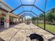 Expansive screened-in patio with dining, seating, and fire pit at 10560 Lake Seminole Ter, Seminole, FL 33772