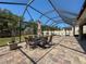 Screened-in patio with dining table, chairs, and lush green yard at 10560 Lake Seminole Ter, Seminole, FL 33772