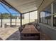 Screened-in patio with large dining table and chairs at 10560 Lake Seminole Ter, Seminole, FL 33772