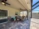 Covered patio area with comfortable seating and ceiling fans at 10560 Lake Seminole Ter, Seminole, FL 33772