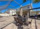 Covered patio with dining table and outdoor kitchen area at 10560 Lake Seminole Ter, Seminole, FL 33772