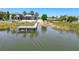 Waterfront property featuring a private dock and picturesque views of the serene water and lush surroundings at 10560 Lake Seminole Ter, Seminole, FL 33772