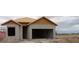 Home under construction featuring concrete block walls and roof framing, with a sign visible at 10657 Crescent Creek Xing, Parrish, FL 34219