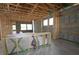 Interior view showcasing the framing of a new home, highlighting the structure and layout at 10657 Crescent Creek Xing, Parrish, FL 34219