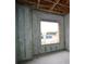 Unfinished room features concrete walls, wooden beams, and window to outside area at 10657 Crescent Creek Xing, Parrish, FL 34219