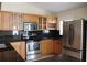This kitchen features stainless steel appliances, granite countertops, ample wooden cabinets and an eat-in countertop at 11014 Peking Pl, Tampa, FL 33624