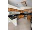 This spacious kitchen features stainless steel appliances, dark countertops, and ample cabinet space at 11014 Peking Pl, Tampa, FL 33624
