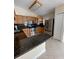 This well-equipped kitchen boasts stainless steel appliances, granite countertops, wooden cabinets, and an eat-in bar at 11014 Peking Pl, Tampa, FL 33624