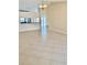 Open-concept living space with tile flooring and natural light, seamlessly connecting to the kitchen at 11014 Peking Pl, Tampa, FL 33624