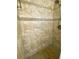 Close-up of tiled shower with beige tile and built-in shower head at 11014 Peking Pl, Tampa, FL 33624