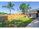 Fenced backyard with fire pit, outdoor grill, and well-maintained lawn at 1111 Lakemont Dr, Valrico, FL 33594