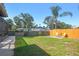 Backyard with ample space, partially fenced, featuring a fire pit and access to the screened-in pool area at 1111 Lakemont Dr, Valrico, FL 33594