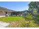 Spacious backyard featuring a screened-in pool, lawn area, and mature landscaping at 1111 Lakemont Dr, Valrico, FL 33594