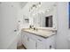 Bathroom featuring a white vanity with marble countertop and modern lighting fixtures at 1111 Lakemont Dr, Valrico, FL 33594