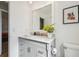 Bathroom featuring a gray vanity with marble countertop, a mirror, and modern fixtures at 1111 Lakemont Dr, Valrico, FL 33594