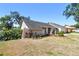 Side view of a charming house featuring a well-maintained lawn and garden at 1111 Lakemont Dr, Valrico, FL 33594